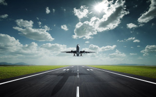 Jetliner flying runway blue sky - cloud and sun free wallpaper