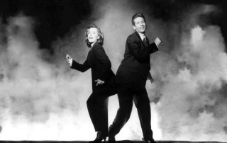 Man woman black suits dancing - smoke behind them free wallpaper