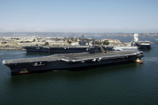 Aircraft carrier docked city harbor - panoramic free wallpaper