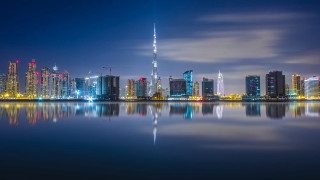City skyline water night blue 2 - a large body of water in front free wallpaper