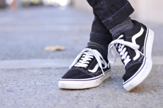 Sneakers jeans outdoors blurry background - their foot free wallpaper