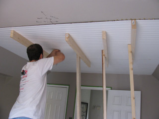 Man working ceiling house unfinished - open ceiling free wallpaper