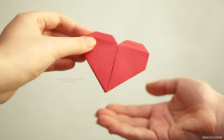 Person holding red origami heart - the other hand free wallpaper