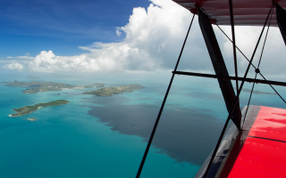 Tropical island plane window ocean - a plane window free wallpaper