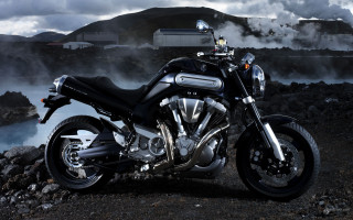 Motorcycle parked rocky road water - the water behind free wallpaper