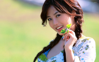 Woman holding leaf smiling green 2 - a leaf free wallpaper