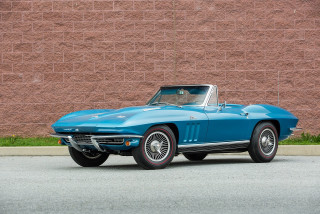 Blue corvette parked brick wall - a brick wall free wallpaper
