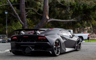 Black sports car tree lined 2 - a truck in the background free wallpaper