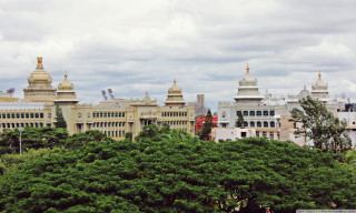 Large building clock tower rooftops - a clock tower in the middle of its free wallpaper