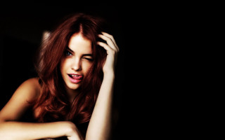 Woman red hair posing dark - a picture in the dark free wallpaper