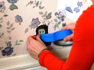 Woman blue tape attach wallpaper 2 - cable wire free wallpaper
