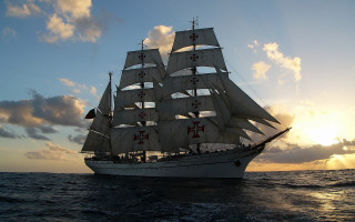 Large white sailboat sailing ocean - sunset free wallpaper