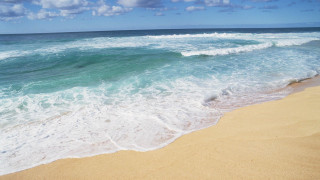 Beach waves blue sky clouds 3 - a surfboard in the foreground free wallpaper