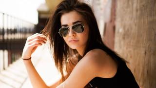 Woman sunglasses leaning wall hand - against a wall free wallpaper