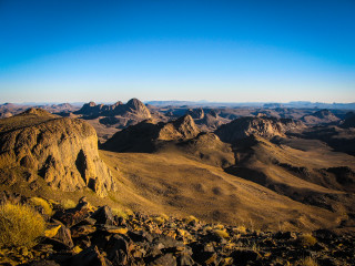 Mountain range blue sky rocks - a view of a mountain range free wallpaper