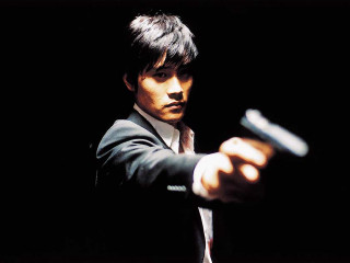 Man suit gun pointing serious 2 - movie still free wallpaper