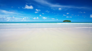 Sandy beach island sky ocean - a small island in the distance free wallpaper