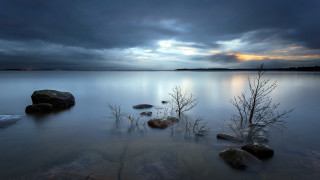 Lake rocks trees water cloudy - a few cloud above free wallpaper