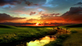 Sunset green field stream clouds - a stream free wallpaper