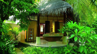 Tropical bathroom with tub thatched - a tropical setting free wallpaper