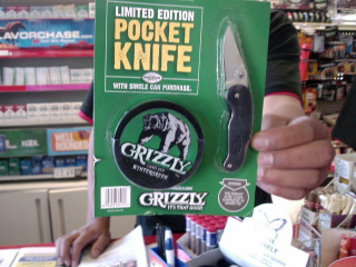 Person holding green package knife - product photo free wallpaper