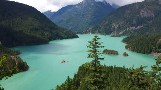 Lake mountains trees boats daytime - a few boat free wallpaper