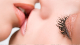 Woman long eyelashes touching face - closed free wallpaper