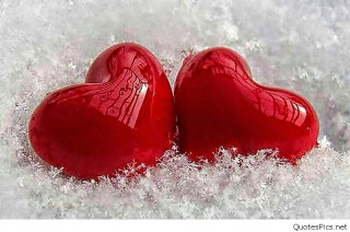 Two red hearts sitting in 2 - object in the middle free wallpaper