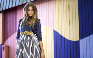 Woman standing colorful building suitcase - her hand and a handbag free wallpaper