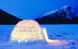 Igloo lit snow night mountains - ice free wallpaper
