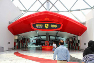 Man woman ferrari museum entrance - open ceiling free wallpaper