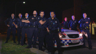 Police officers nighttime arms crossed - a police car free wallpaper