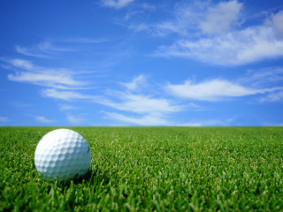 Golf ball lush green grass - a golf ball free wallpaper
