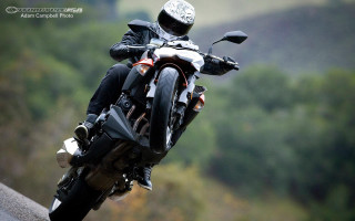 Motorcycle person road trees hill - motion blur free wallpaper