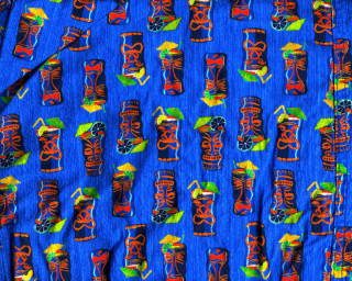 Blue tiki masks green leaf - detail free wallpaper