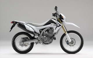 White motorcycle parked white floor - a gray wall behind free wallpaper