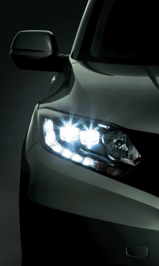 Car headlight closeup dark background - free light wallpaper for mobile