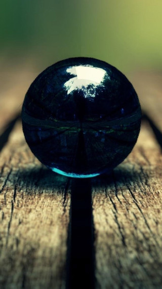 Glass ball wooden table tree - a macro photograph free wallpaper for mobile