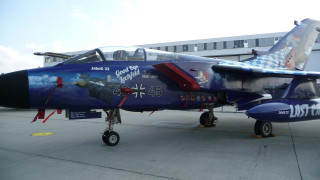 Blue fighter jet airbrush bernd - top of an airport tarmac free wallpaper