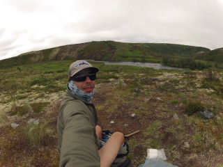 Man sitting rock field mountain - ultra wide angle free wallpaper