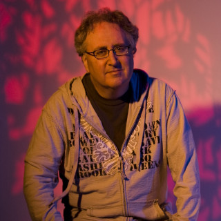 Man grey hoodie holding remote - grey free wallpaper for tablet