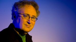 Man glasses green shirt serious - academic free wallpaper