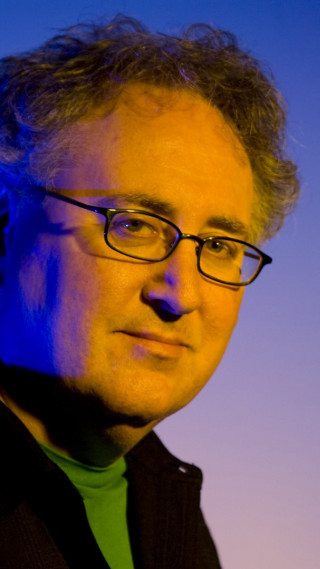 Man glasses green shirt blue - academic free wallpaper for mobile