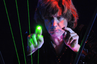 Man holding green light pointing - a man holding free wallpaper for desktop