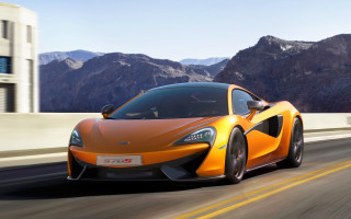 Orange sports car mountains building - a orange sports car free wallpaper