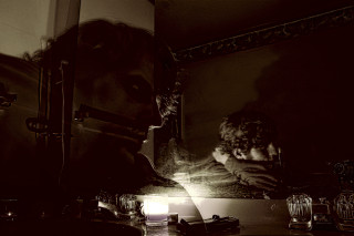 Woman looking reflection mirror candle - deep shadow free wallpaper