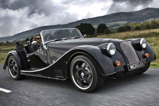 Vintage black sports car driving - a man driving free wallpaper