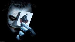 Man holding card joker face - dark shadow free wallpaper