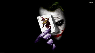 Joker holding card joker face - a card free wallpaper