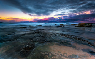 Sunset rocky beach cloudy sky 7 - a sunset over a rocky beach free wallpaper